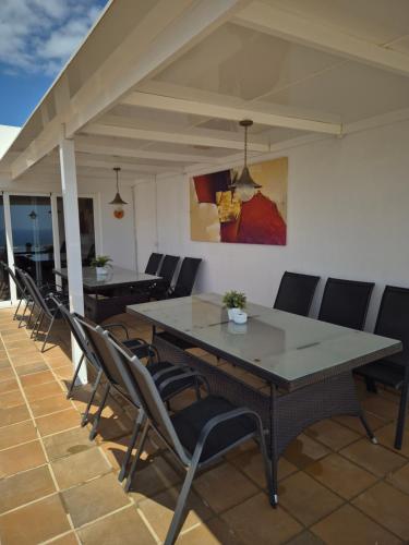 a group of tables and chairs on a patio at Villa Feliza in Güime