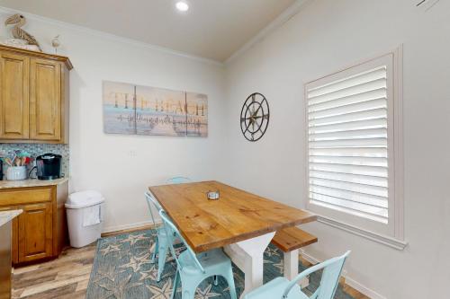 a dining room with a wooden table and chairs at Bella Vista & Four Winds House in Padre Island