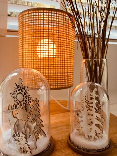 two glass domes with a figurine of a man with trees on them at Chalet 190 La Belle Durbuy in Durbuy