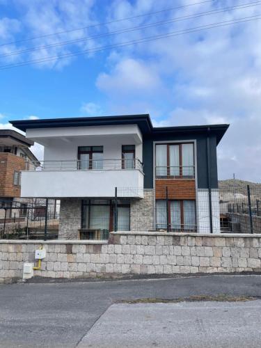 a house on the side of a stone wall at Villa Efes in Hisarcık