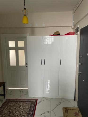 a white room with a door and a rug at Villa Efes in Hisarcık
