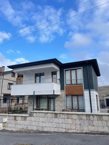 a white and black house on a stone wall at Villa Efes in Hisarcık