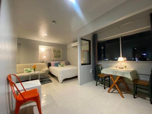 a living room with a bed and a couch at Patunam Building , Shopping , Airport Rail link in Bangkok