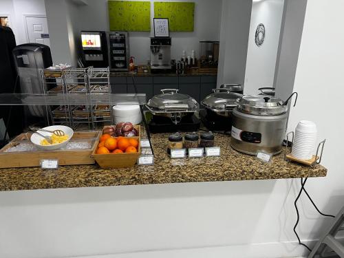 a kitchen counter with a bunch of food on it at Baymont by Wyndham Jacksonville Airport in Jacksonville