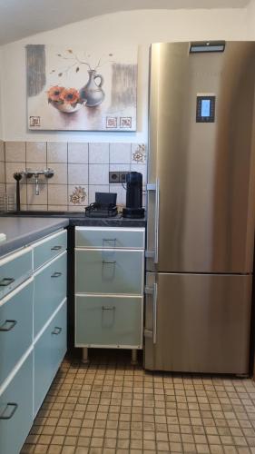a kitchen with a stainless steel refrigerator at Ferienwohnung Oberburg in Solingen