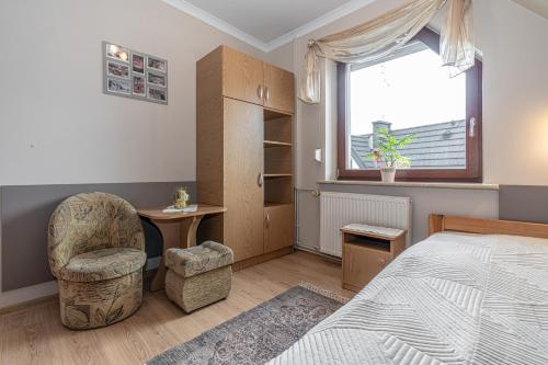 a bedroom with a bed and a desk and a chair at Willa Jaś I Małgosia in Kościelisko