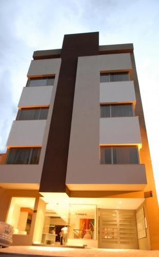 a tall white building with many windows at Hotel Ankara Suites in Salta