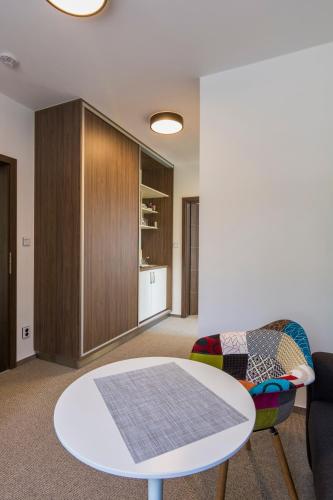 a living room with a coffee table and a cabinet at Resort Mezná in Hřensko
