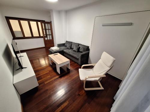 a living room with a couch and a table at Alquiler Vacacional PC in Noya