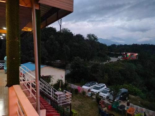 a view of a parking lot with cars and a fire truck at Chaukhamba view Resort in Gupta Kāshi