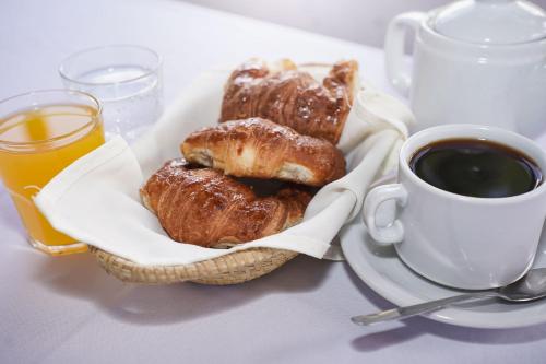 a plate of pastries and a cup of coffee on a table at Hospedaje La Pasada in Tafí del Valle