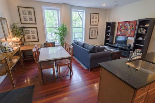 a living room with a couch and a table at Above Maxwell Wine Bar - Super Central 2Bed 2Bath in Washington, D.C.