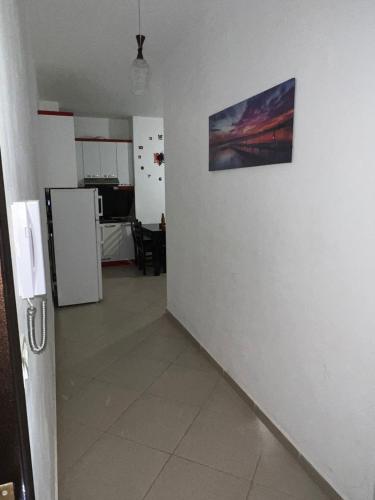 a room with a white wall with a picture on it at Sea flavor in Shëngjin