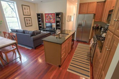 a kitchen and living room with a refrigerator freezer at Above Maxwell Wine Bar - Super Central 2Bed 2Bath in Washington, D.C.