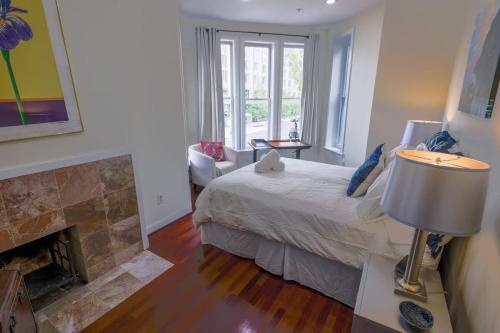 a bedroom with a bed and a fireplace at Above Maxwell Wine Bar - Super Central 2Bed 2Bath in Washington, D.C.