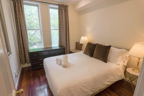 a bedroom with a white bed with two pillows at Above Maxwell Wine Bar - Super Central 2Bed 2Bath in Washington, D.C.
