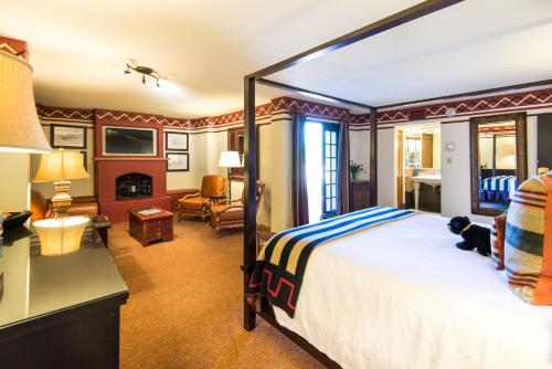 a bedroom with a large bed and a living room at Inn & Spa at Loretto in Santa Fe