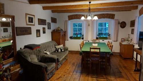 a living room with a couch and a table at Domek z duszą in Szklarska Poręba