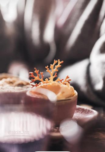 a cupcake with a snowman decoration on top of it at Stein Inn in Stein