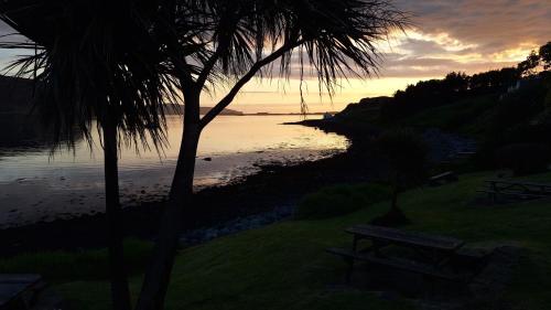 a bench sitting next to the water with a sunset at Stein Inn in Stein