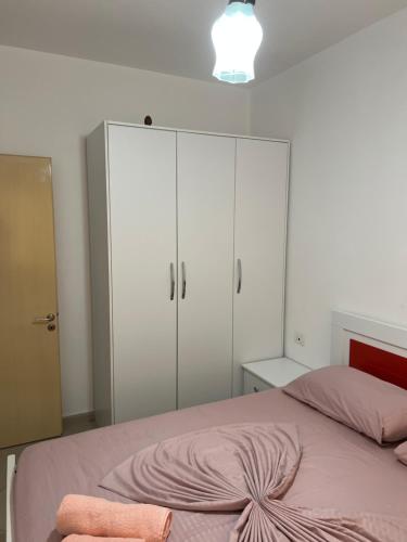 a bedroom with a bed with white cabinets at Sea flavor in Shëngjin