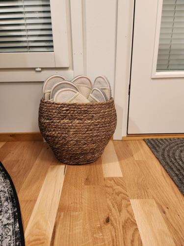 a basket sitting on a floor next to a door at Nice and new apartment with own terrace and yard - Oulu, Limingantulli in Oulu