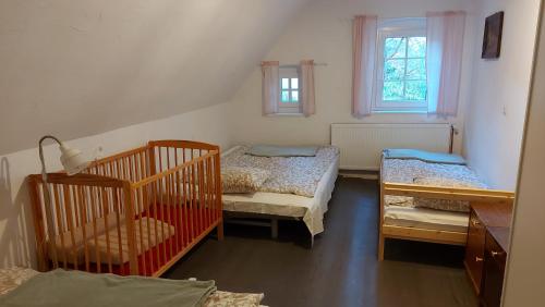 a small room with two cribs and a room with at Domek z duszą in Szklarska Poręba