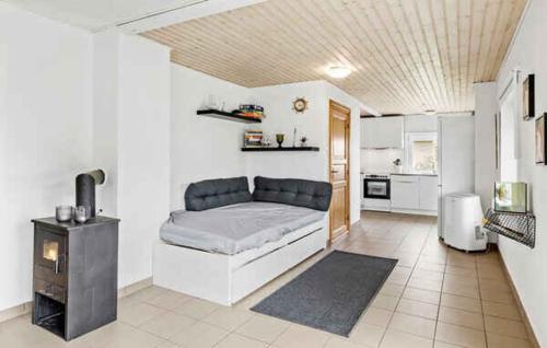 a living room with a couch and a stove at Lovely House With A View Of The Limfjord in Øsløs