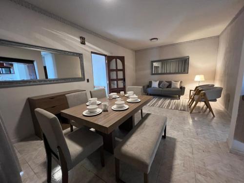 a living room with a wooden table and chairs at La casa de Carmen- Moderno apartamento in Ezequiel Montes