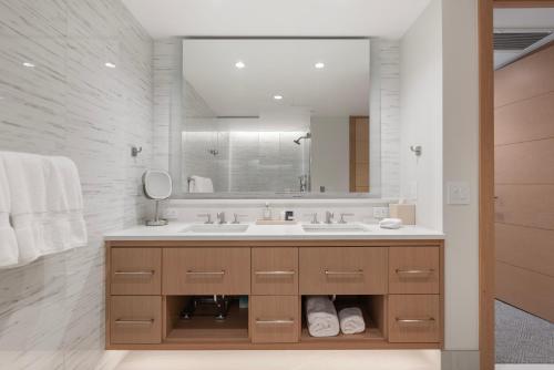 a bathroom with a sink and a large mirror at Snowmass Lux Getaway by Snowmass Vacations in Snowmass Village