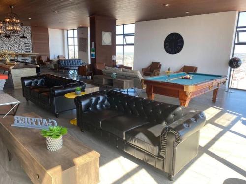 a living room with couches and a pool table at Downtown Tijuana 1 BR Ave Revolucion Suite 1st floor in Tijuana