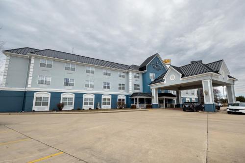 a large building with a parking lot in front of it at Country Inn & Suites by Radisson, Effingham, IL in Effingham