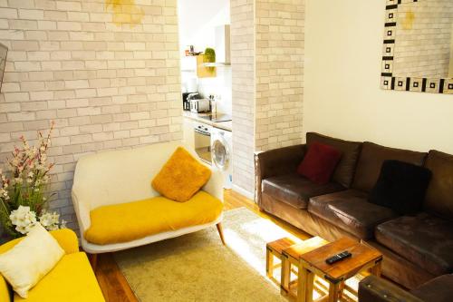 a living room with a couch and a table at 5 bedroom house near cardiff city. in Cardiff