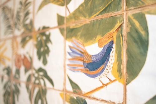 a mosaic of a bird on a tile wall at DunaTwinhouse in Dömös