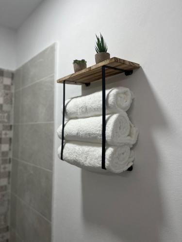 a stack of towels on a shelf in a bathroom at El Encanto de Jerez in Jerez de la Frontera
