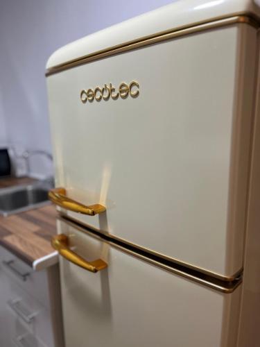 a white refrigerator withzos on it in a kitchen at El Encanto de Jerez in Jerez de la Frontera
