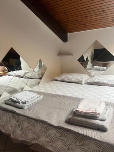 a bedroom with a bed with folded towels on it at Casa Parco Dora Torino - Intero Monolocale vicino al Centro e Allianz Stadium Juventus in Turin