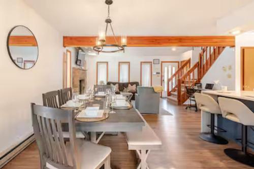 a dining room with a long table and chairs at Cozy Cabin at Poconos With Hot Tub and Fire Pit in East Stroudsburg