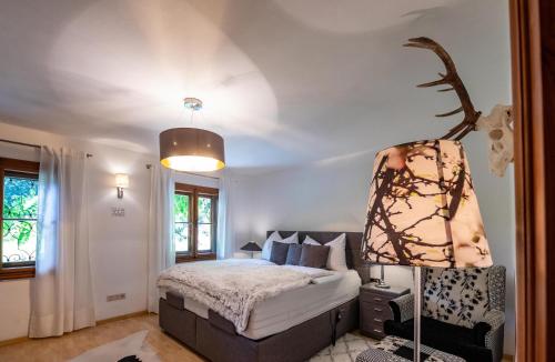 a bedroom with a bed and a lamp in it at Alpenrelax Haus Weidmannsheil wohnen im romantischen Forsthaus in Werfen
