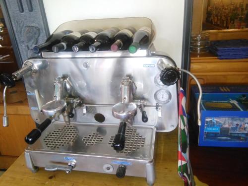 a espresso machine with a bunch of wine bottles at Ristorante Hotel Mira in Sestri Levante