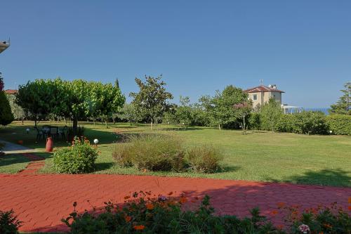 a park with a field of grass and a house at TAMMY'S GARDEN HOUSE in Leptokaria