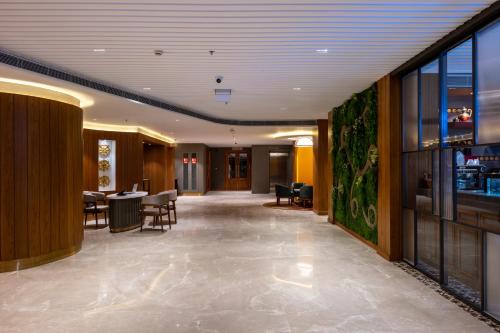 a hallway with chairs and tables in a building at Charmwood Hotel in Leh