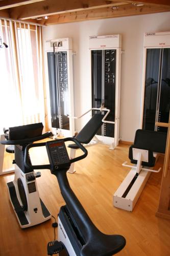 a gym with a treadmill and two exercise bikes at Alpenblick in Klosters
