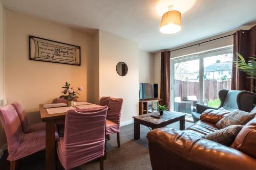 a living room with a couch and a table at 6 beds in 4 bedrooms house in Southampton
