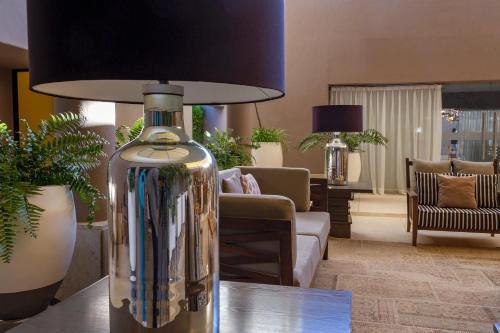 a vase sitting on a table in a living room at Alesia - Boutique Hotel & Spa in Aguascalientes