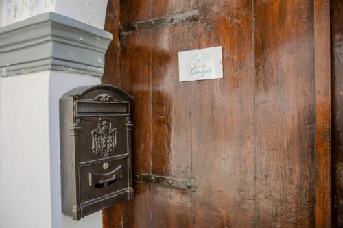 an old mailbox on a wall next to a wooden wall at Casa Lanzara in Morano Calabro