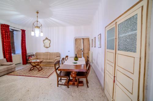 a living room with a table and a couch at Casa Lanzara in Morano Calabro