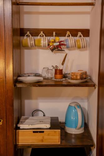 a cupboard with a teapot and dishes in it at Casa Lanzara in Morano Calabro