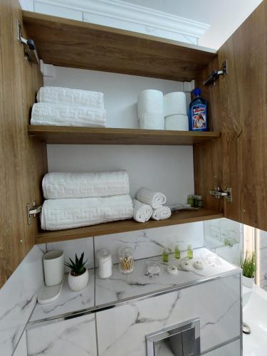 a bathroom with a glass counter with towels at ONYX - Vision Aparthotel in Braşov