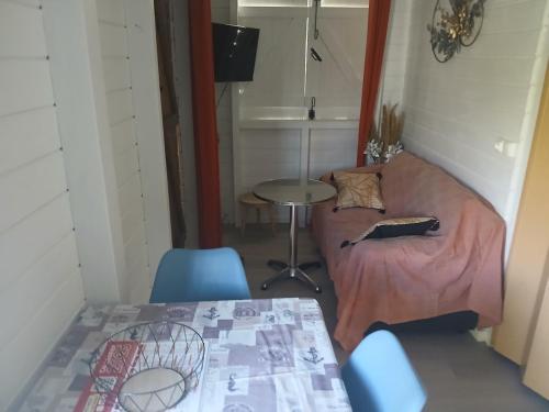 a small living room with a couch and a table at Bungalow Lolo Moringa in Bouillante
